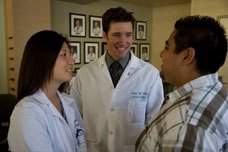 Steven Mills, MD, with assistant and patient