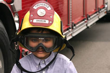 child wearing fireman's helmet